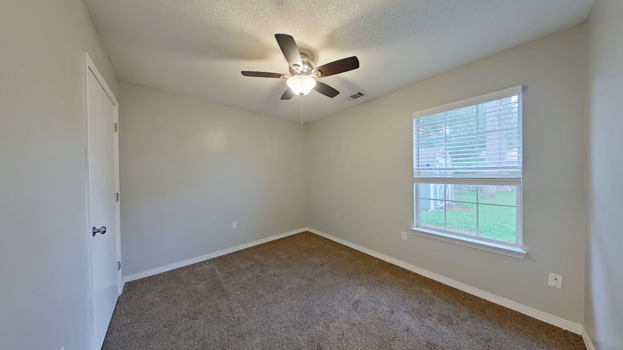 212 Water Oak Lane Crestview, FL 32539 - Photo 24 of 29 an empty room with a window and ceiling fan