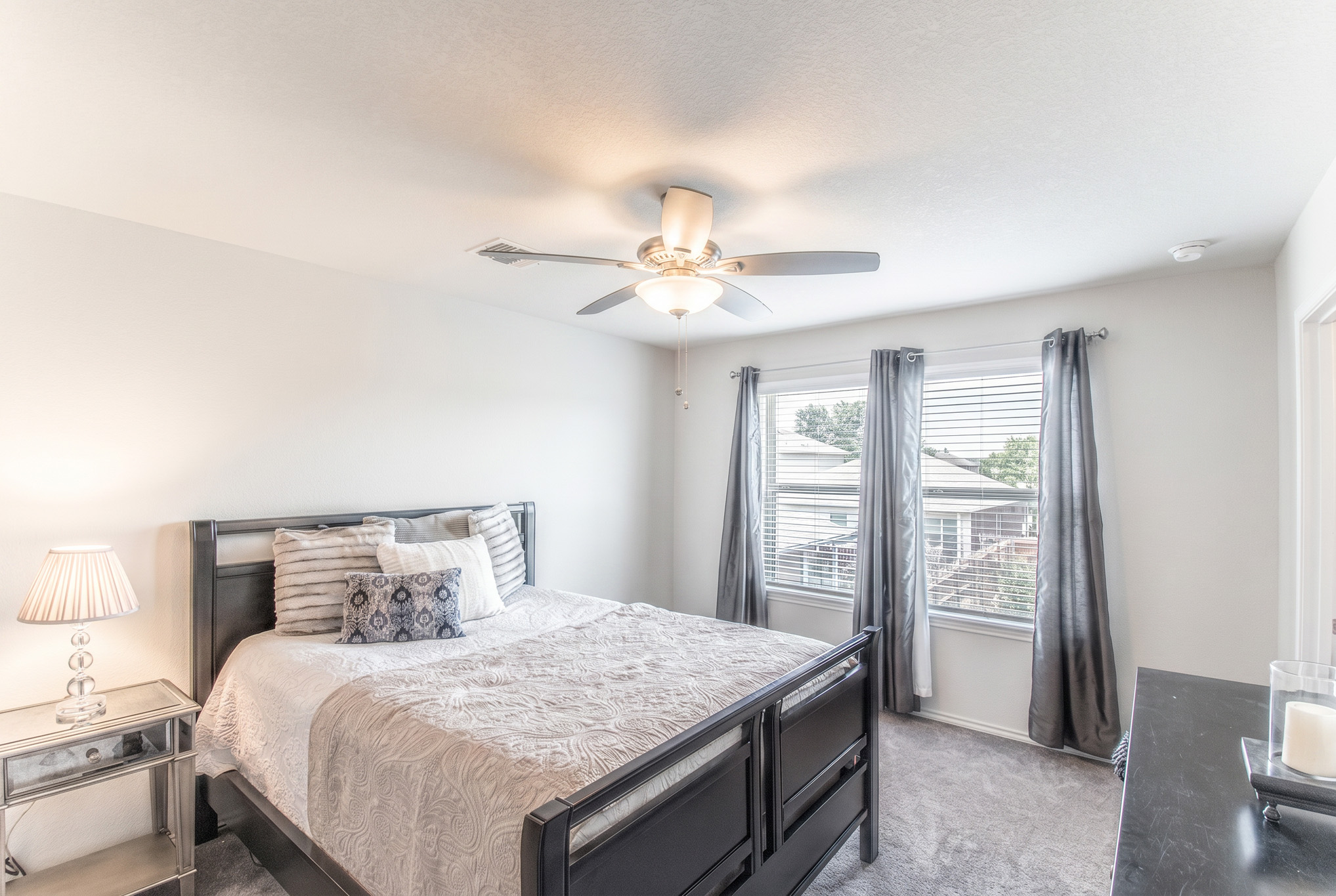 192 Spotted Rail Ridge Leander, TX 78641 - Photo 13 of 34 a bedroom with a large bed and a chandelier