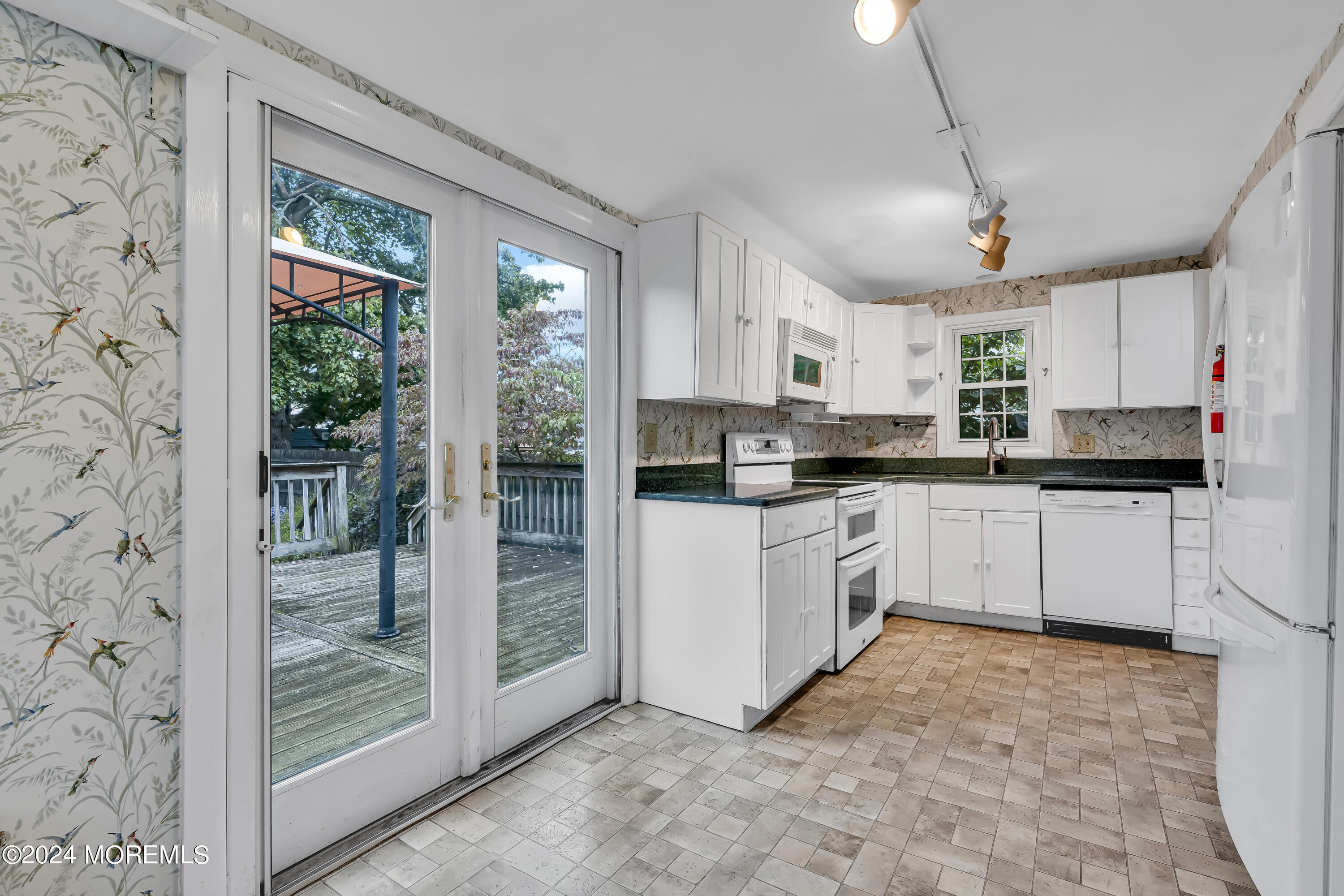 45 2nd Street Keyport, NJ 07735 - Photo 11 of 24 a kitchen with stainless steel appliances granite countertop a stove a sink and a refrigerator