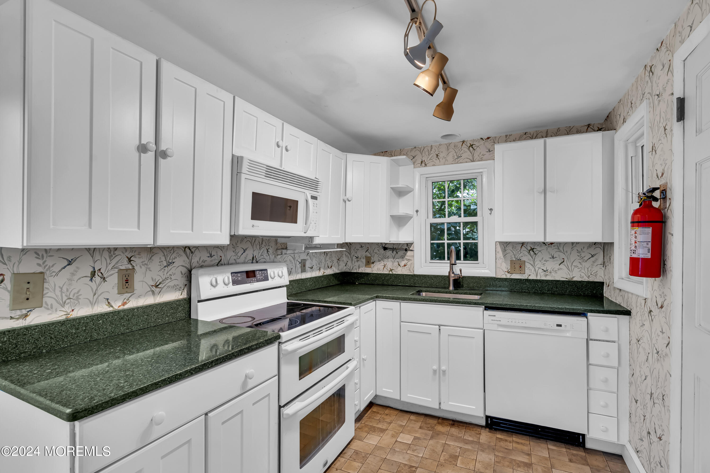 45 2nd Street Keyport, NJ 07735 - Photo 12 of 24 a kitchen with granite countertop a sink stainless steel appliances and cabinets