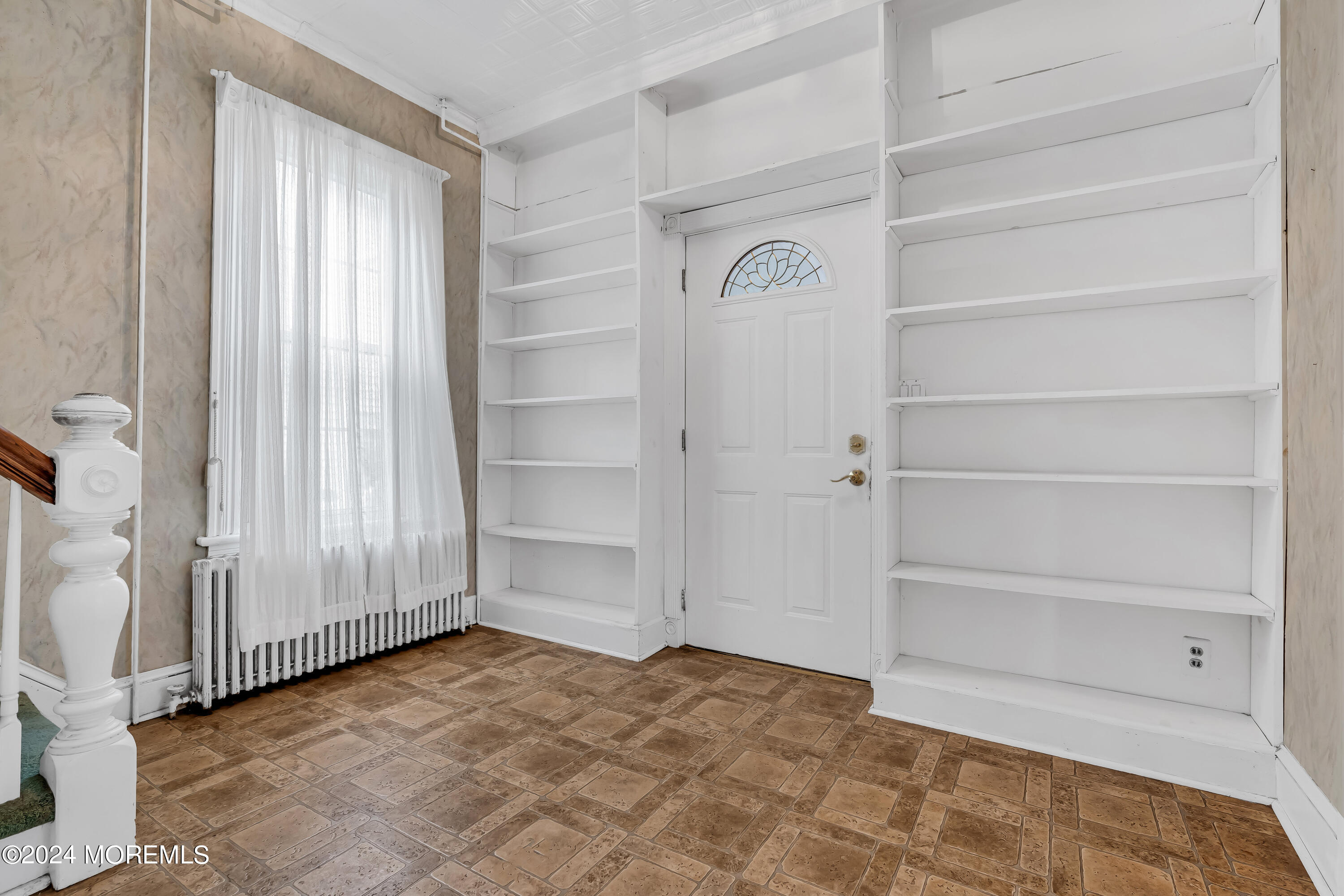 45 2nd Street Keyport, NJ 07735 - Photo 5 of 24 a view of an empty room with cabinet and a window