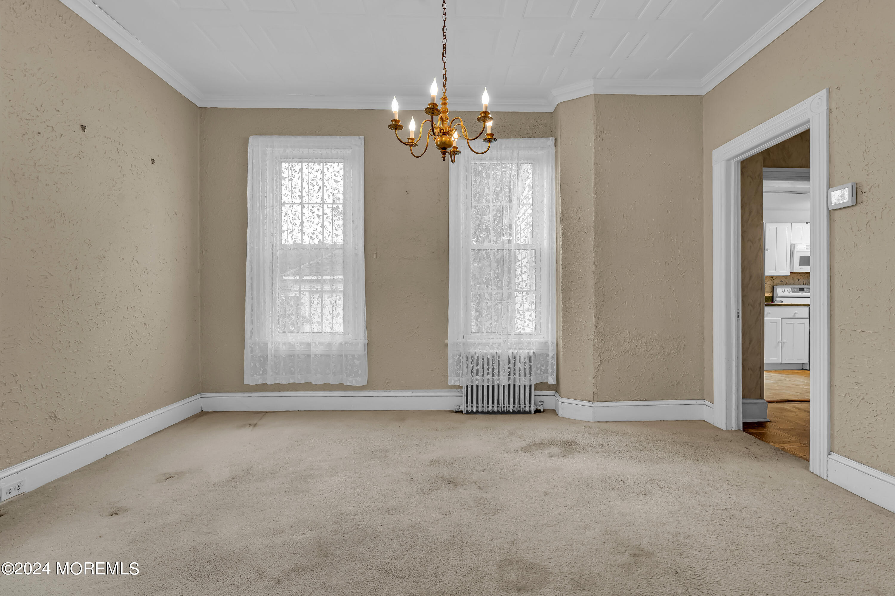 45 2nd Street Keyport, NJ 07735 - Photo 9 of 24 an empty room with chandelier fan and windows