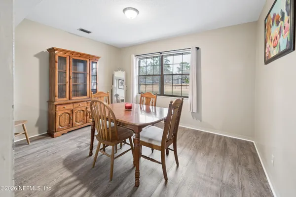 a view of a dining room with furniture window and wooden floor