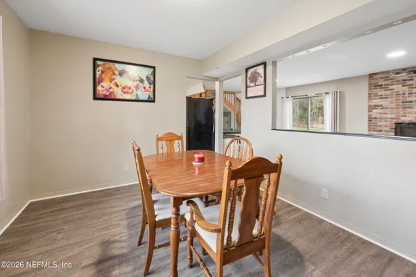 a dining room with furniture and window