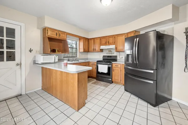 a kitchen with stainless steel appliances granite countertop a refrigerator sink and cabinets