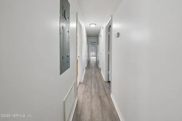 a view of hallway with wooden floor