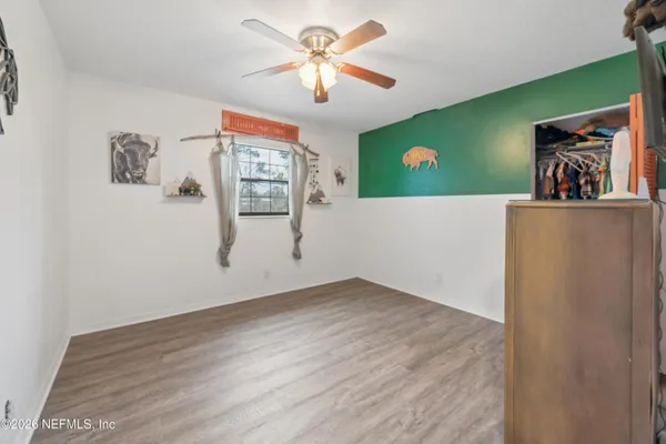 a view of a living room with hardwood floor and a ceiling fan