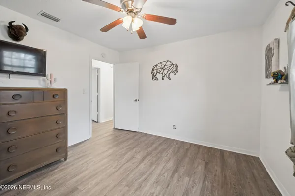 a view of an empty room with a cabinet and a flat screen tv