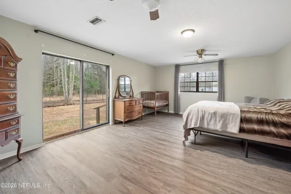 a bedroom with a bed and large window