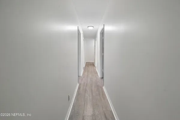 a view of hallway with wooden floor