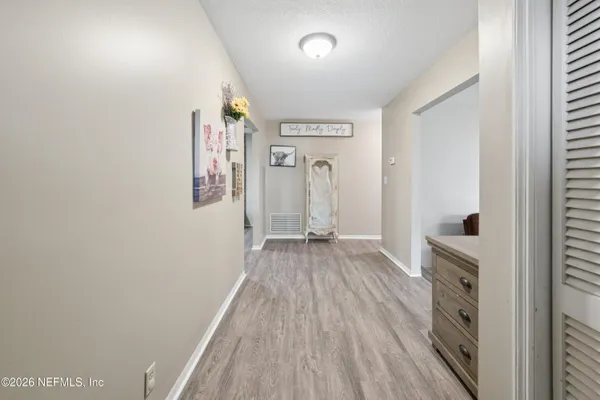 a view of hallway with wooden floor