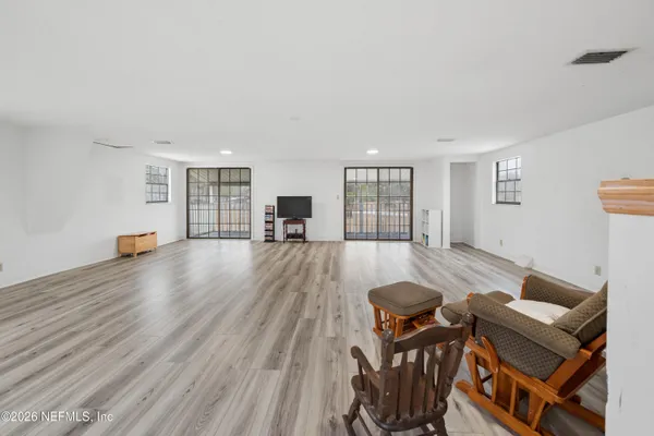 a living room with furniture and a wooden floor