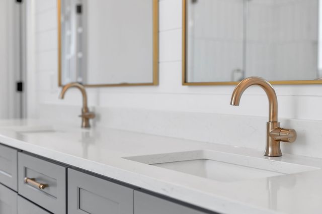 a bathroom with a double vanity sink and a mirror