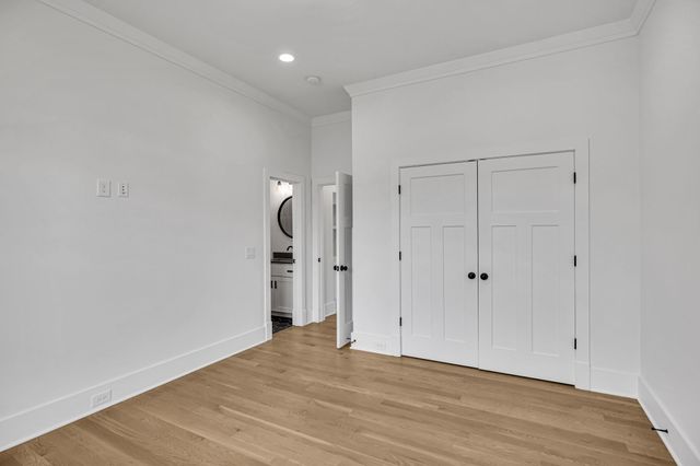 a bathroom with a granite countertop sink mirror vanity and toilet