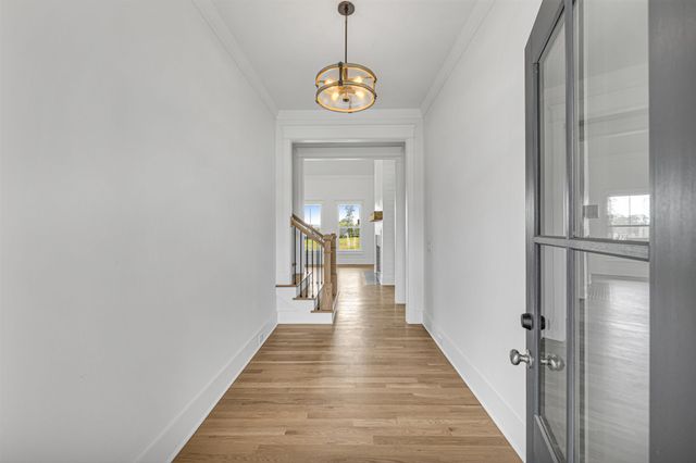 a view of an empty room with a window and fireplace