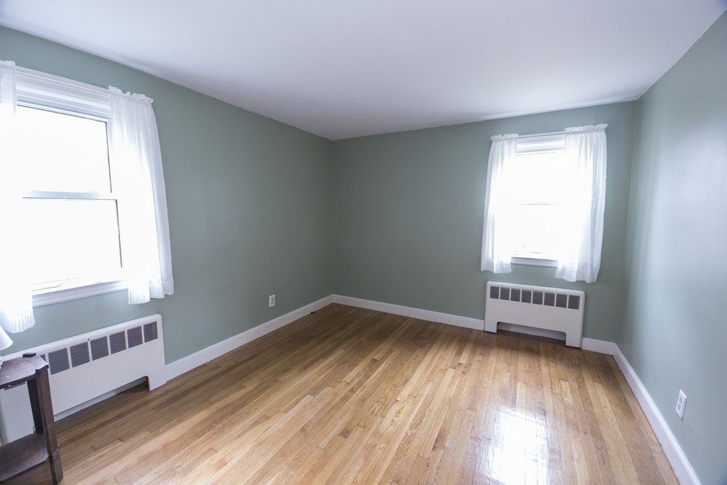 85 Russ Street Randolph, MA 02368 - Photo 11 of 16 a view of an empty room with wooden floor and a window