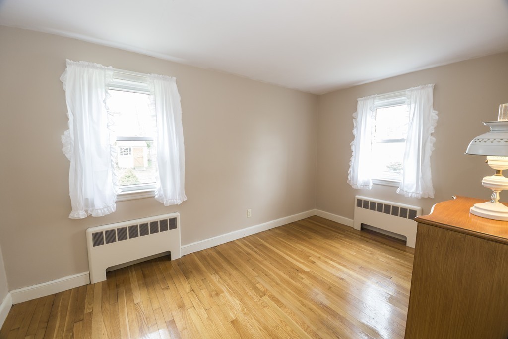 85 Russ Street Randolph, MA 02368 - Photo 12 of 16 a view of an empty room with a window and wooden floor