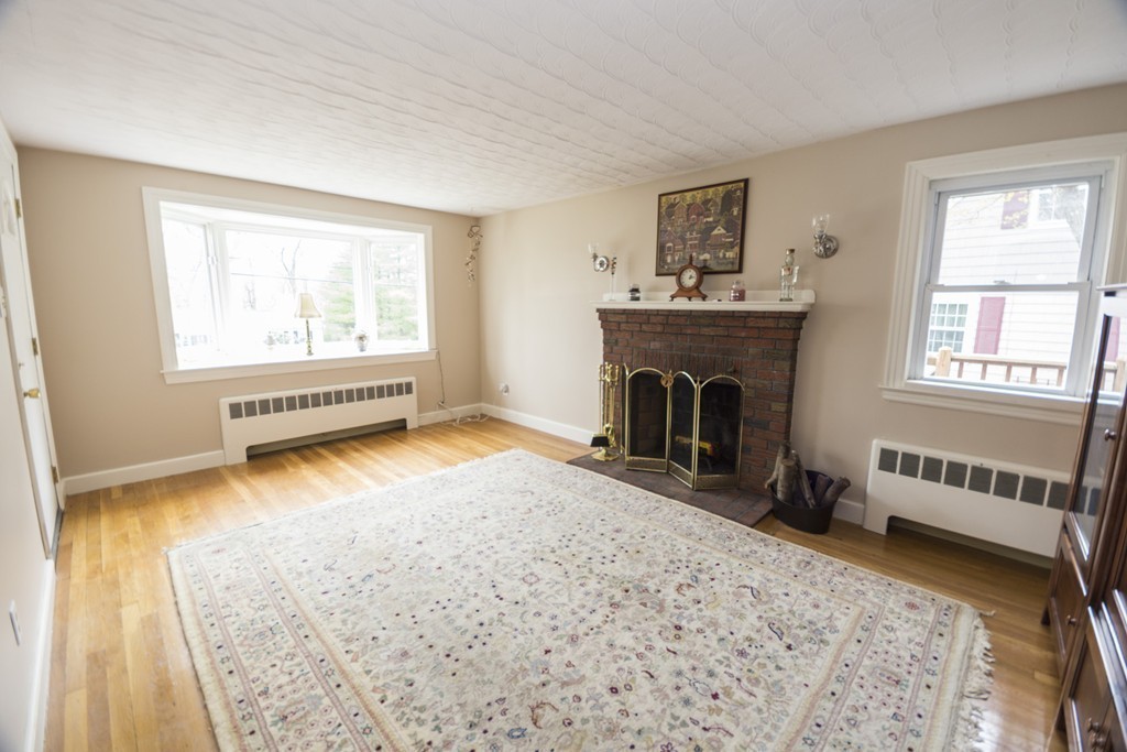 85 Russ Street Randolph, MA 02368 - Photo 3 of 16 a view of an empty room with a window and a fireplace