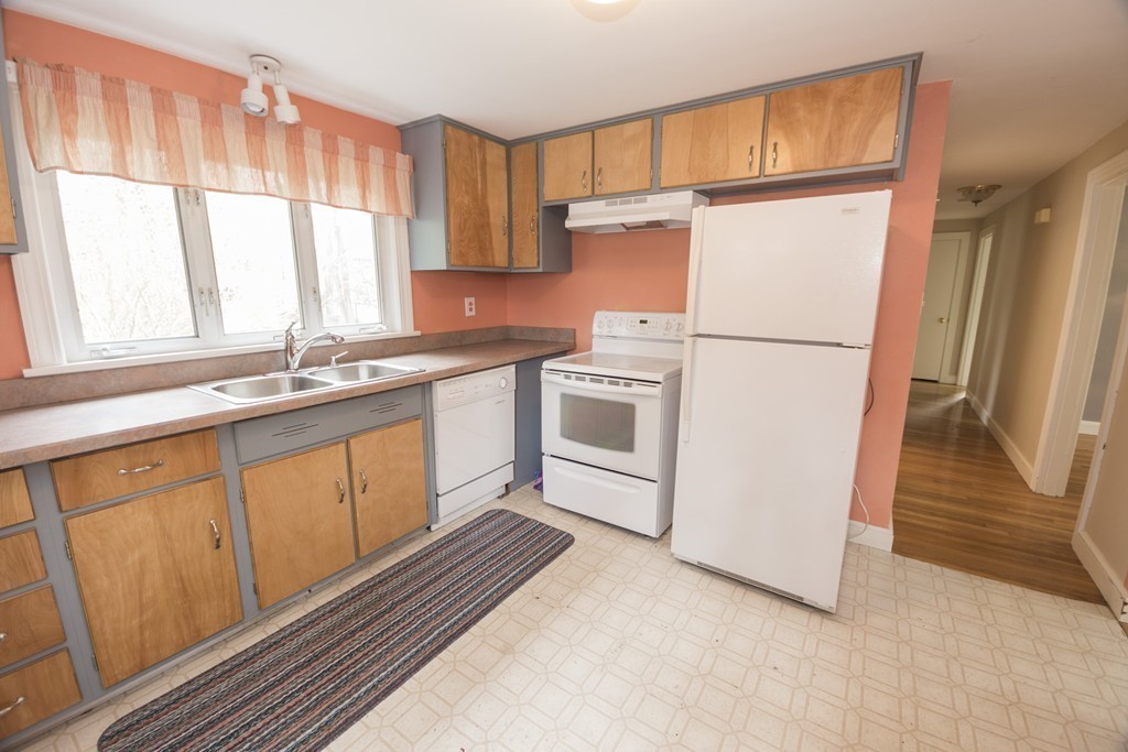 85 Russ Street Randolph, MA 02368 - Photo 6 of 16 a kitchen with stainless steel appliances granite countertop a refrigerator sink and cabinets