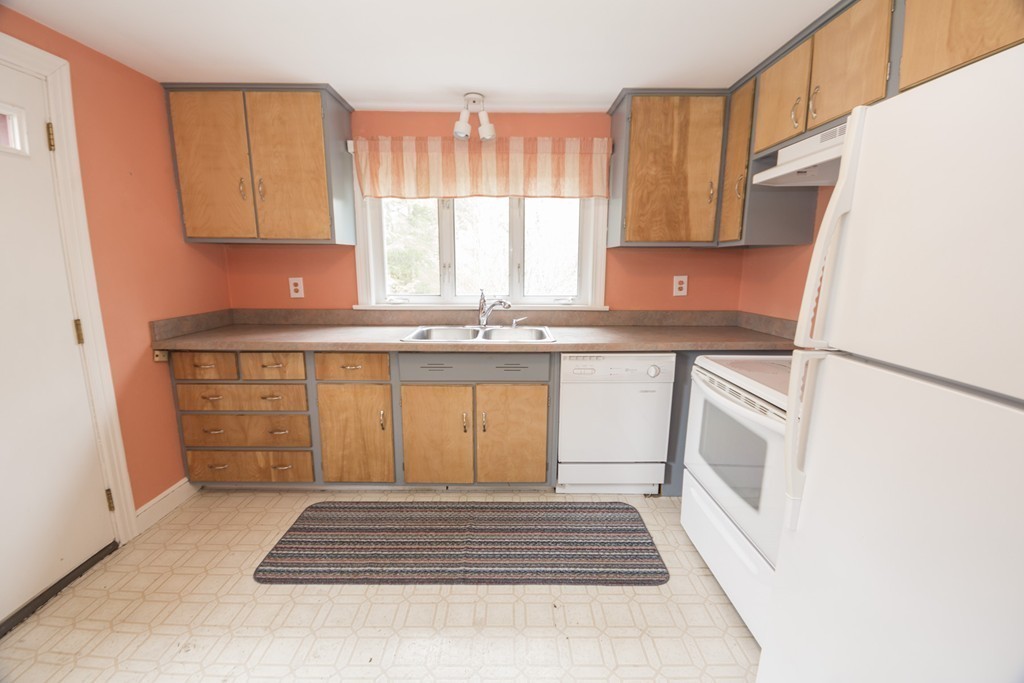 85 Russ Street Randolph, MA 02368 - Photo 7 of 16 a kitchen with stainless steel appliances granite countertop a stove a sink and a refrigerator