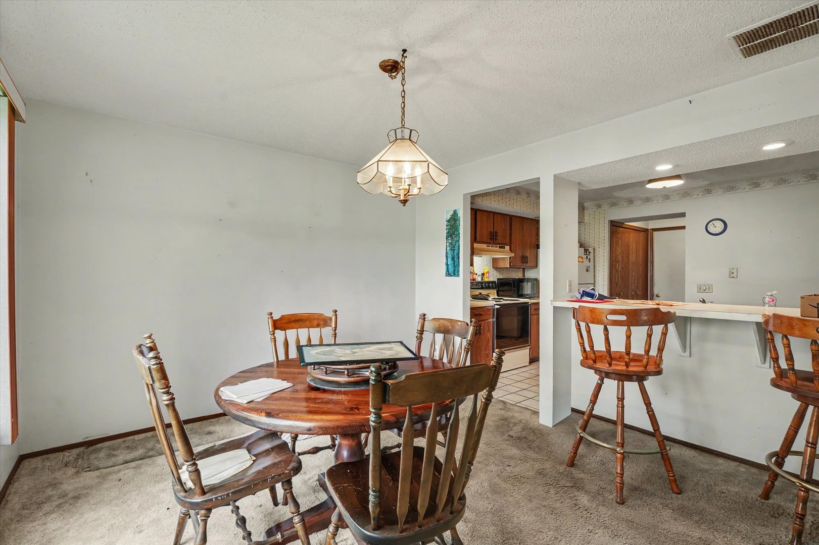 711 Higgins Road Champaign, IL 61822 - Photo 13 of 23 a view of a dining room with furniture and a chandelier