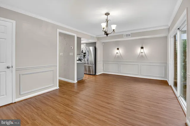 a view of kitchen with granite countertop cabinets and wooden floor