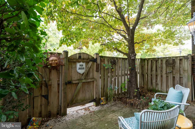 a backyard of a house with outdoor seating and trees