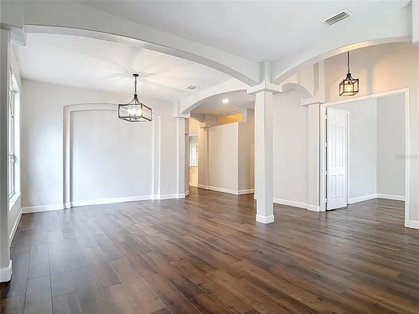 a view of a kitchen with a sink dishwasher and wooden floor