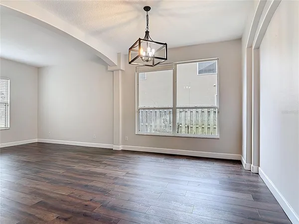 a large kitchen with kitchen island a stove a sink a center island and wooden floor