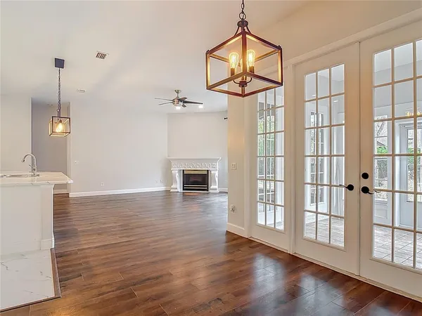 a view of an empty room with wooden floor