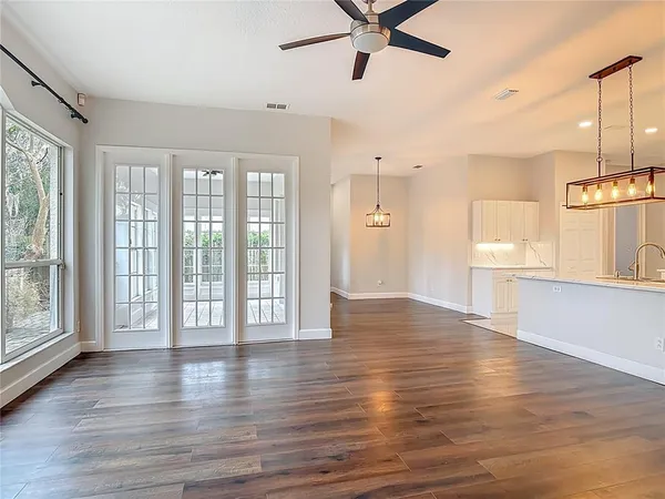 a view of an empty room with wooden floor