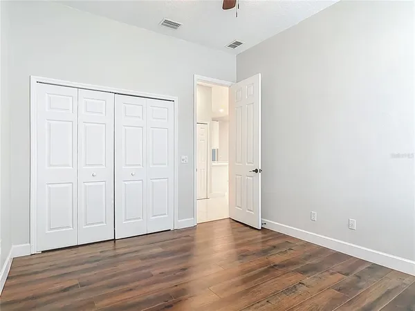 a view of walk in closet with empty racks