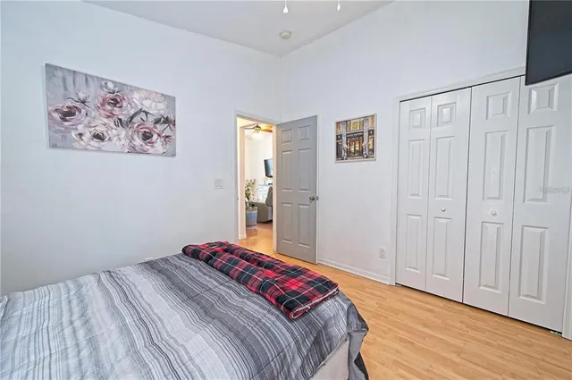 a bedroom with a bed and a painting on the wall