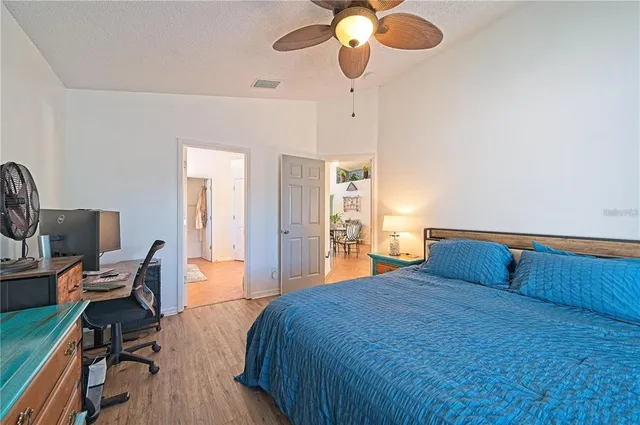 a bedroom with a bed and wooden floor