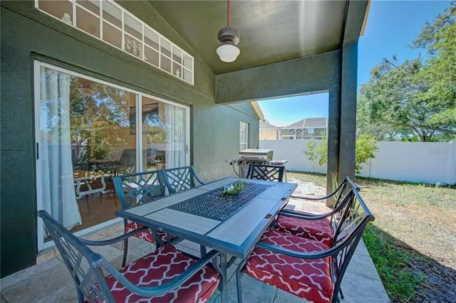 a view of a dining table and chairs in the balcony