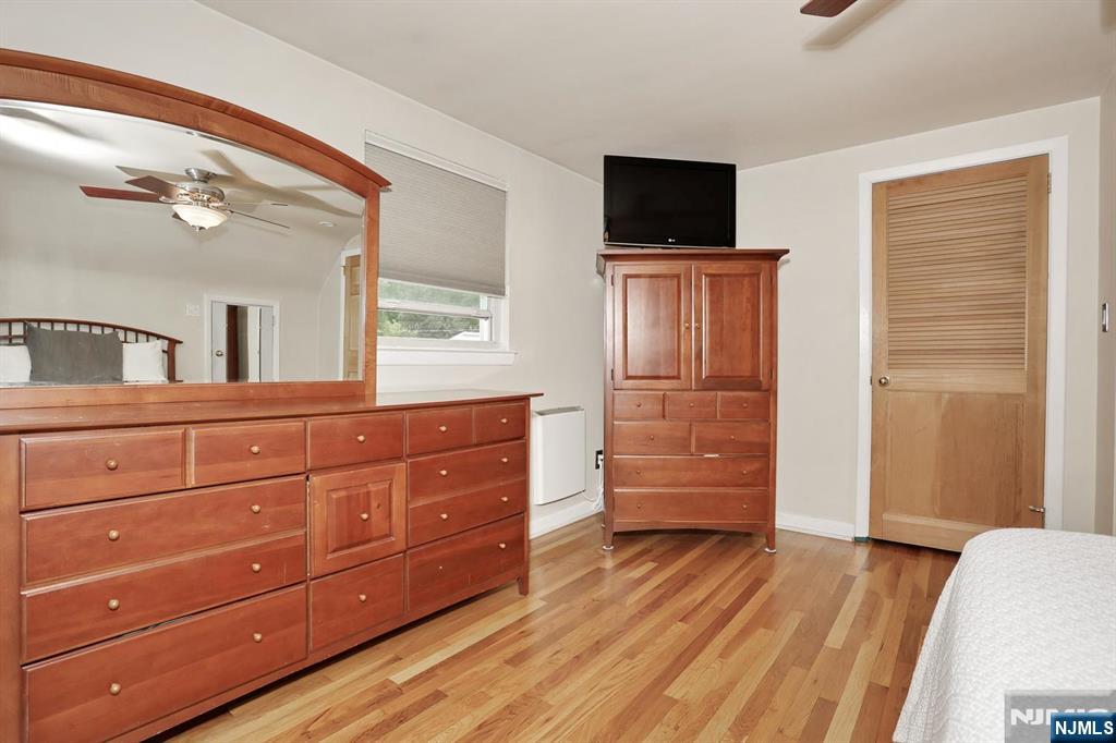 87 Barbara Road Dumont, NJ 07628 - Photo 31 of 48 a bedroom with a bed and wooden floor