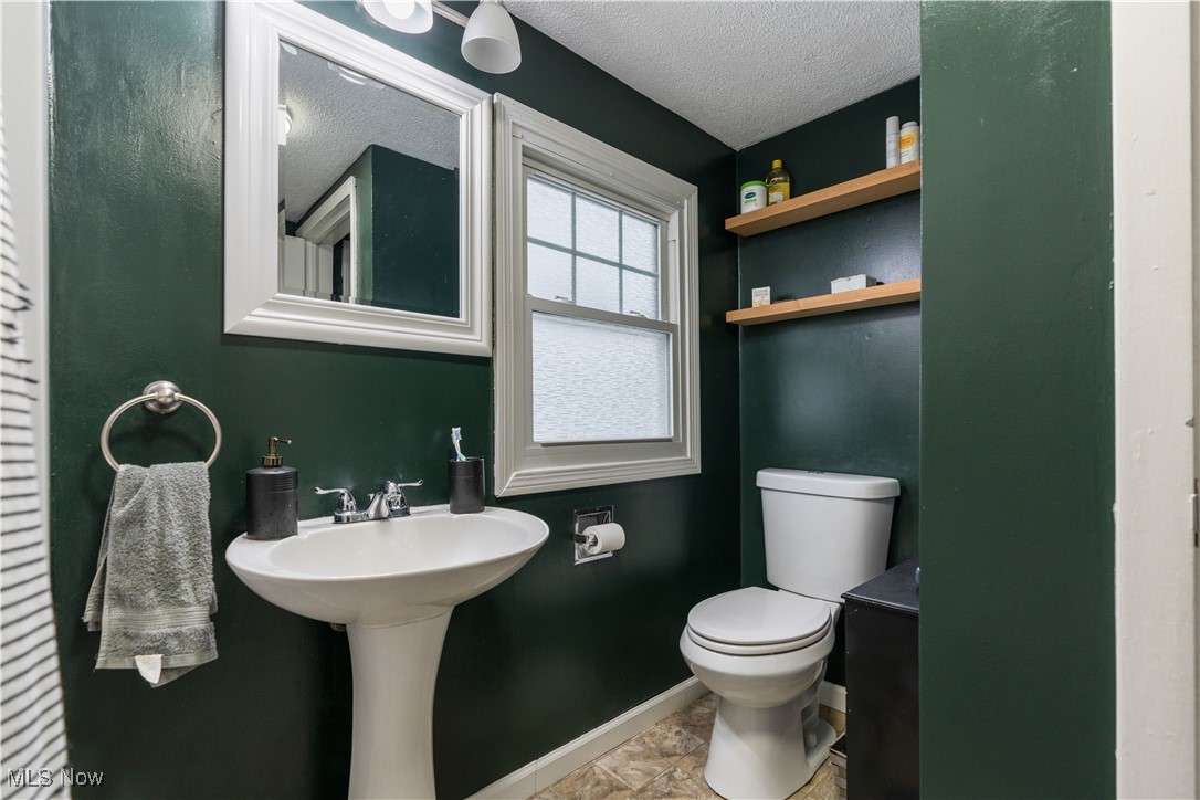 6003 Keller Road Akron, OH 44319 - Photo 14 of 17 Master Bathroom with a textured ceiling, sink, toilet, and shower