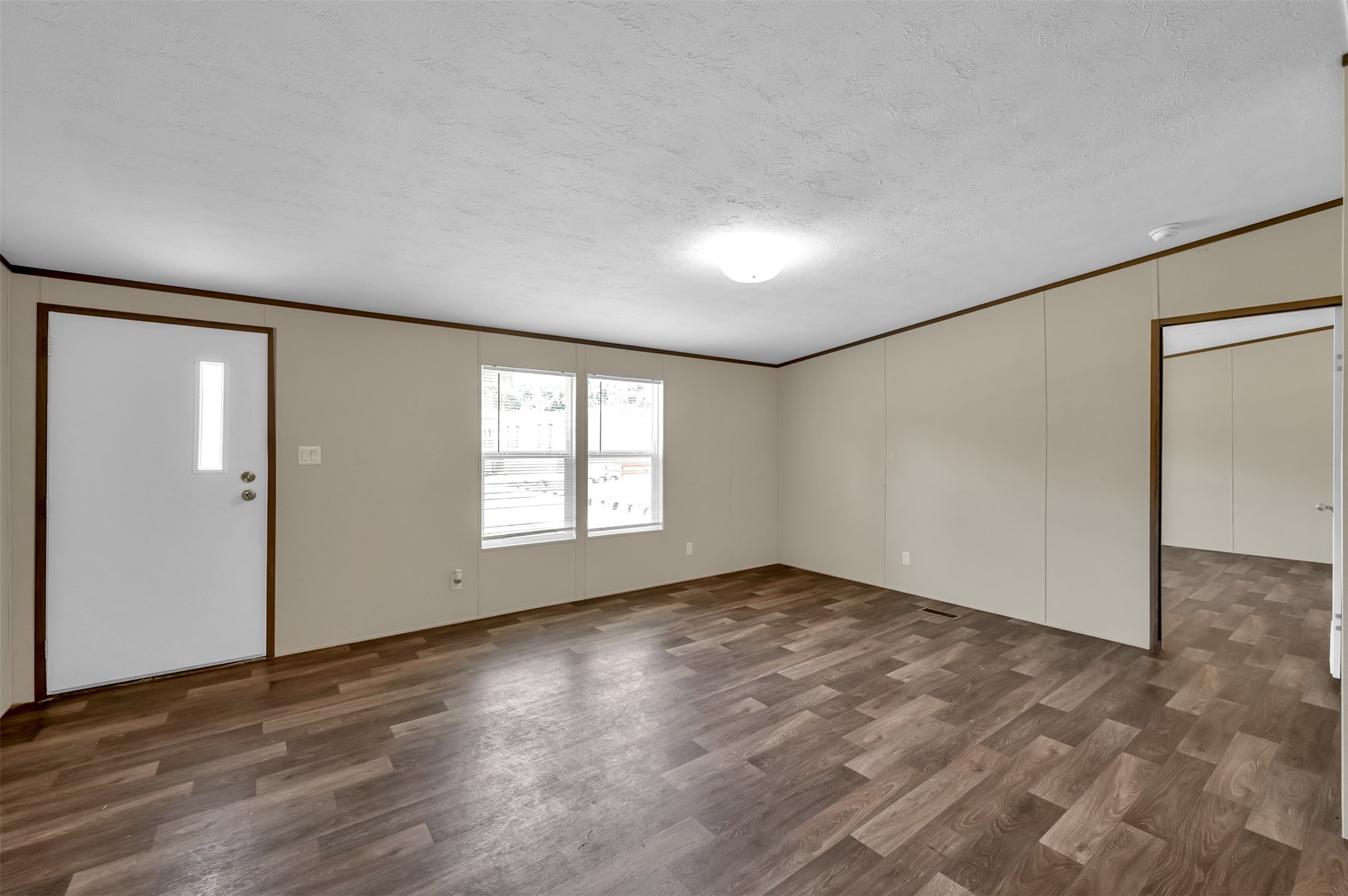 26768 A Dobbin-Huffsmith Road Magnolia, TX 77354 - Photo 10 of 29 an empty room with wooden floor and windows