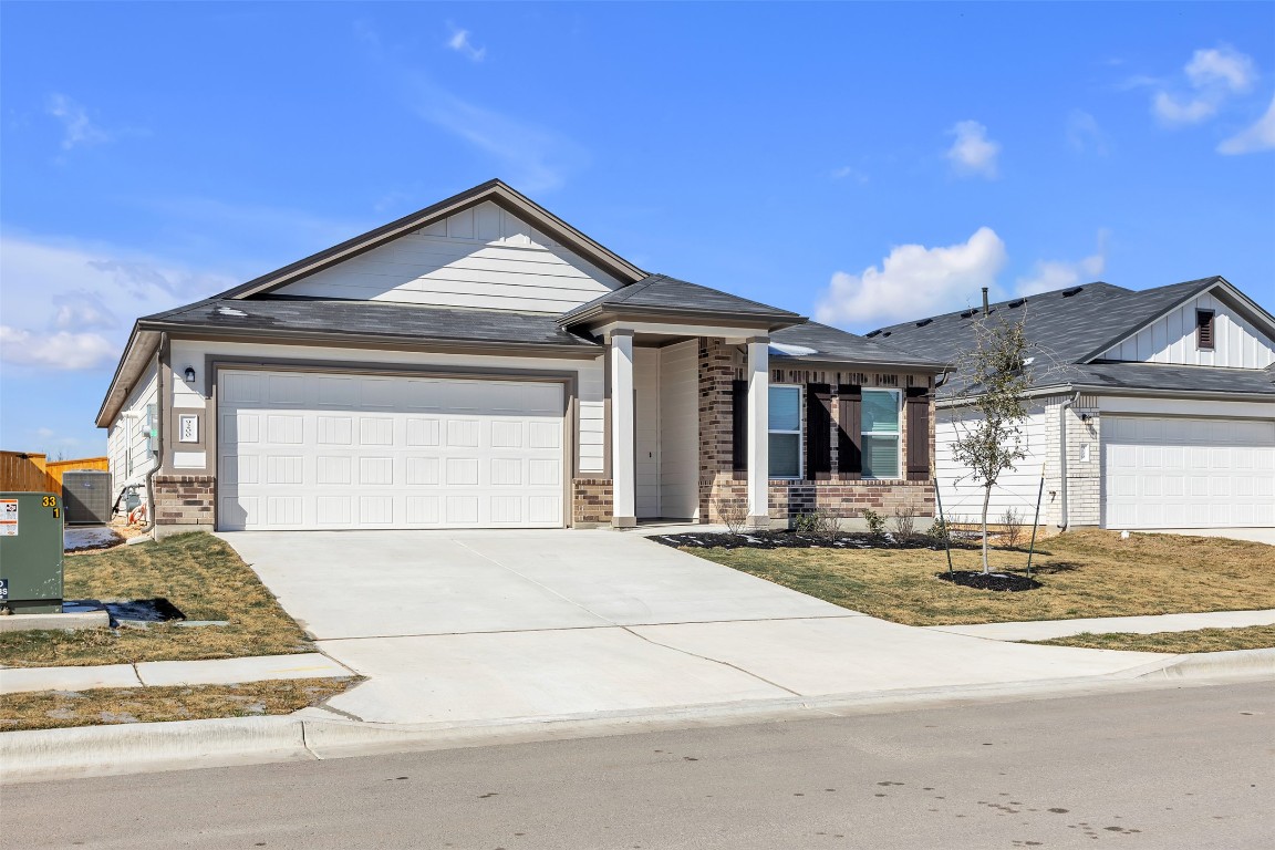 9200 Furman Drive Austin, TX 78747 - Photo 1 of 15 Single story home with concrete driveway, a garage, and brick siding