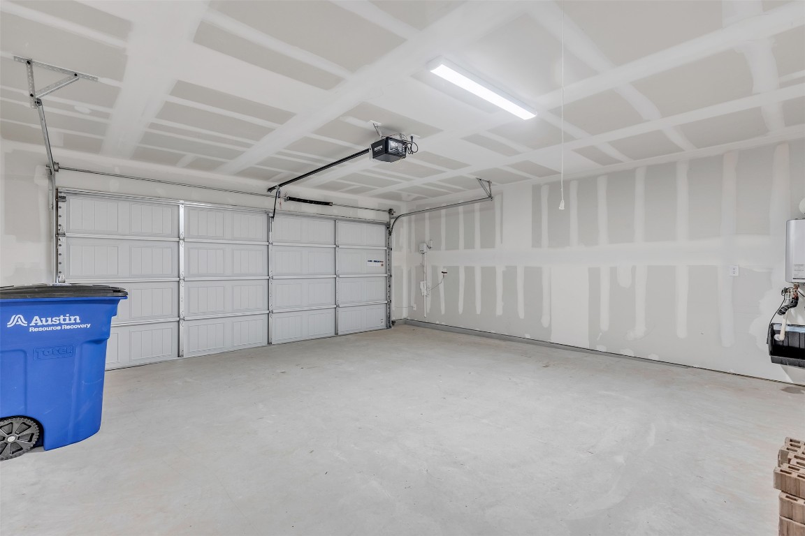 9200 Furman Drive Austin, TX 78747 - Photo 13 of 15 Garage featuring a garage door opener