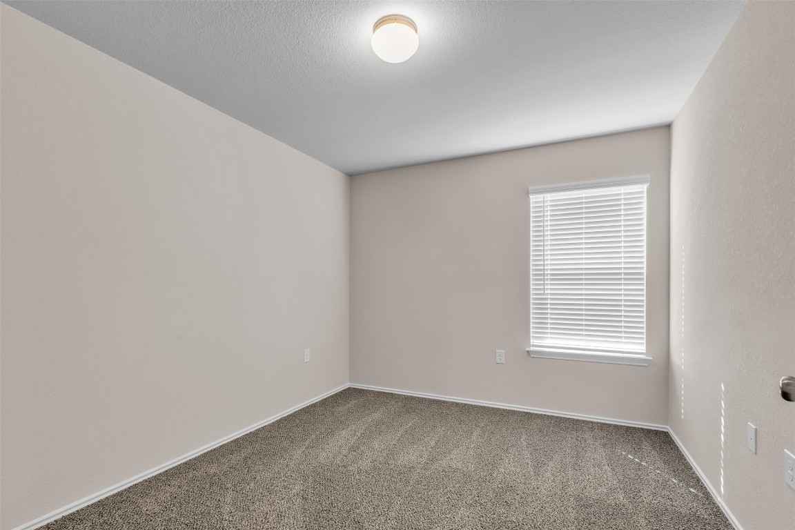 9200 Furman Drive Austin, TX 78747 - Photo 9 of 15 Carpeted empty room with baseboards