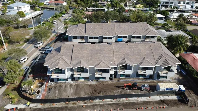 an aerial view of a house with garden and outdoor seating