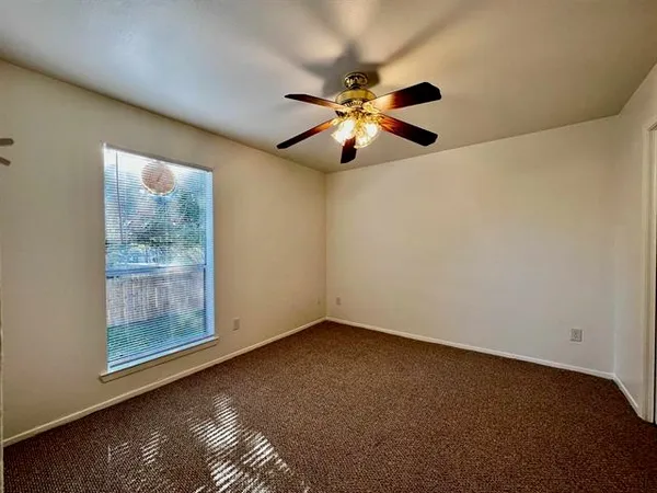 a view of room with window and ceiling fan
