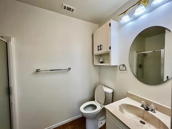 a bathroom with a sink mirror toilet and vanity