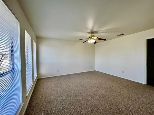 a view of a livingroom with a ceiling fan and window