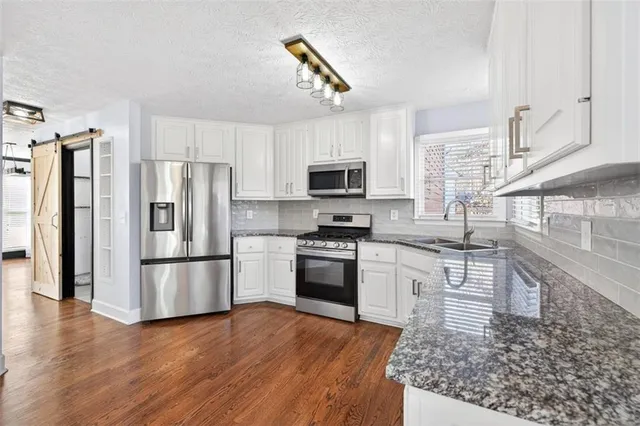 an empty room with a ceiling fan and a window