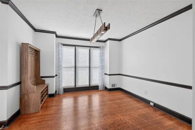 a view of a room with a ceiling fan and window