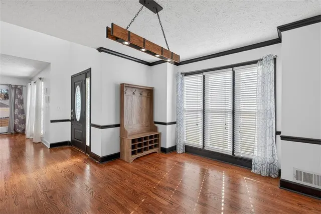 an empty room with a window and a ceiling fan