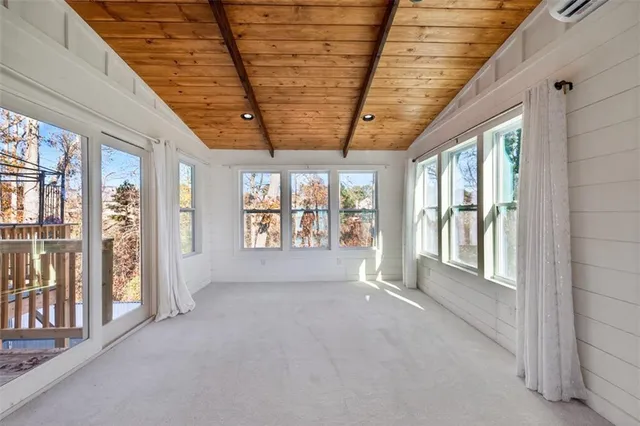 a view of a livingroom with a ceiling fan & a window