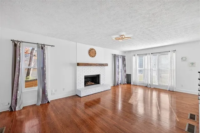 a view of an empty room with glass door and a window